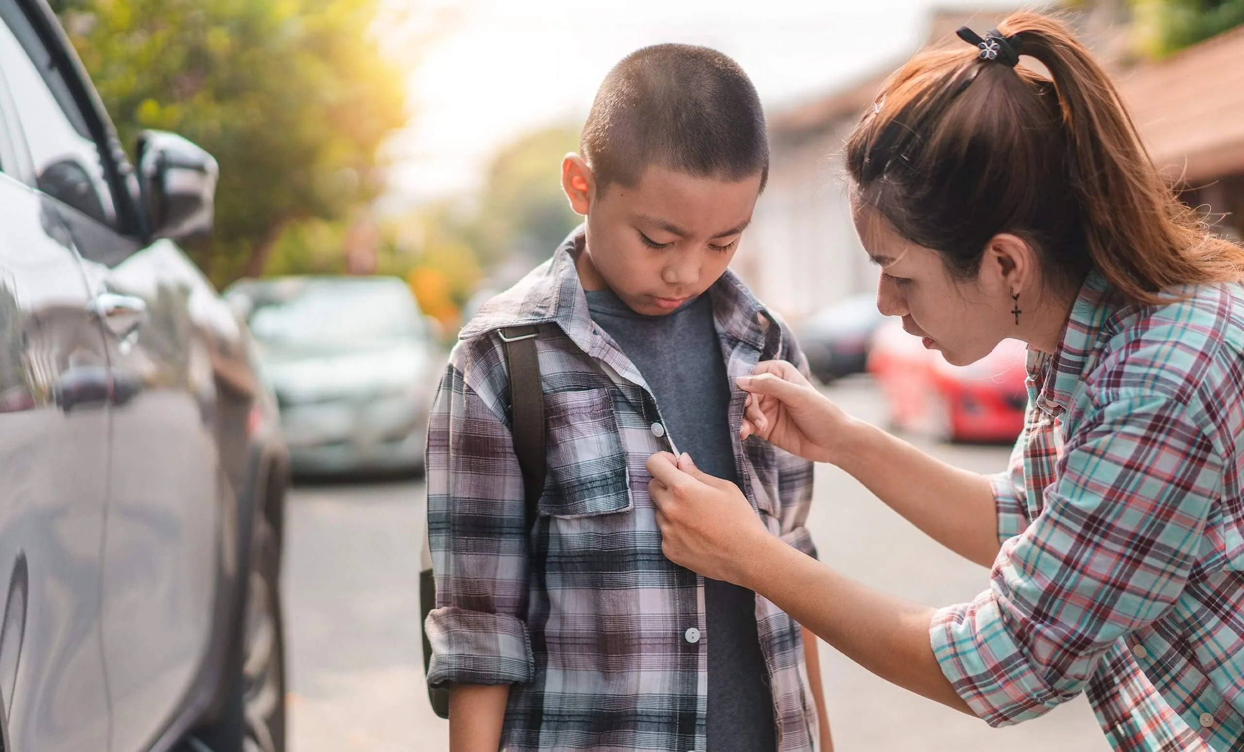 A mom helping her son get ready for school in 2025, with text overlay about using a Texas title loan from Latte Loans for back-to-school expenses.